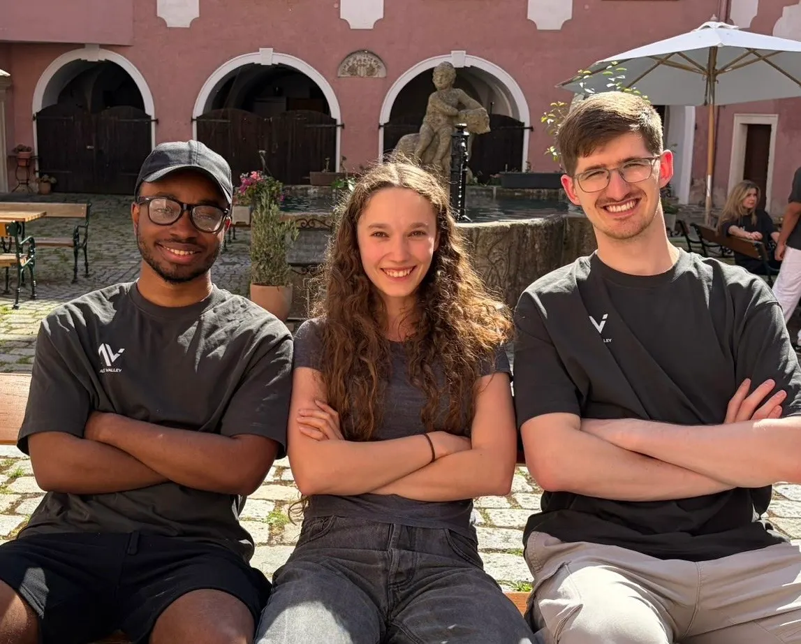 The CallCrew team sitting together in a courtyard
